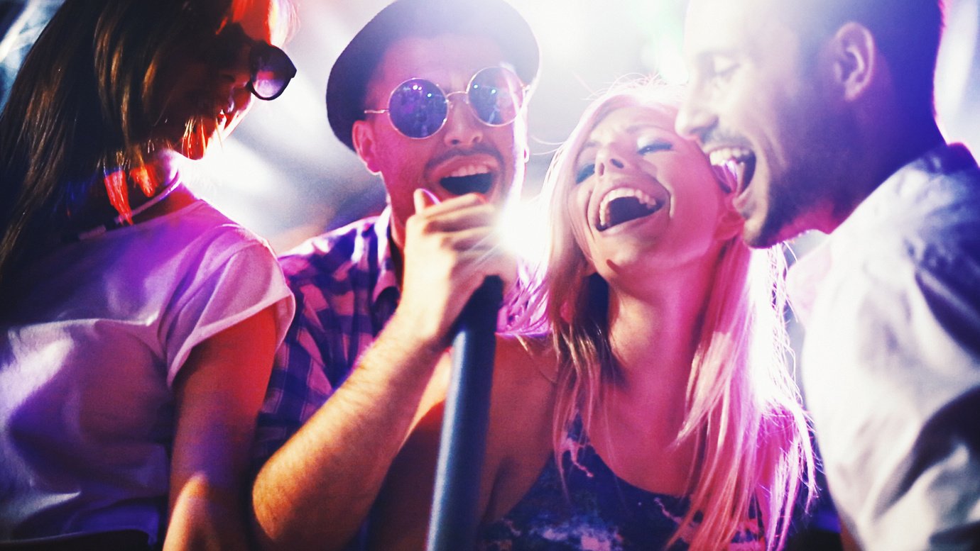 Group of people singing karaoke.